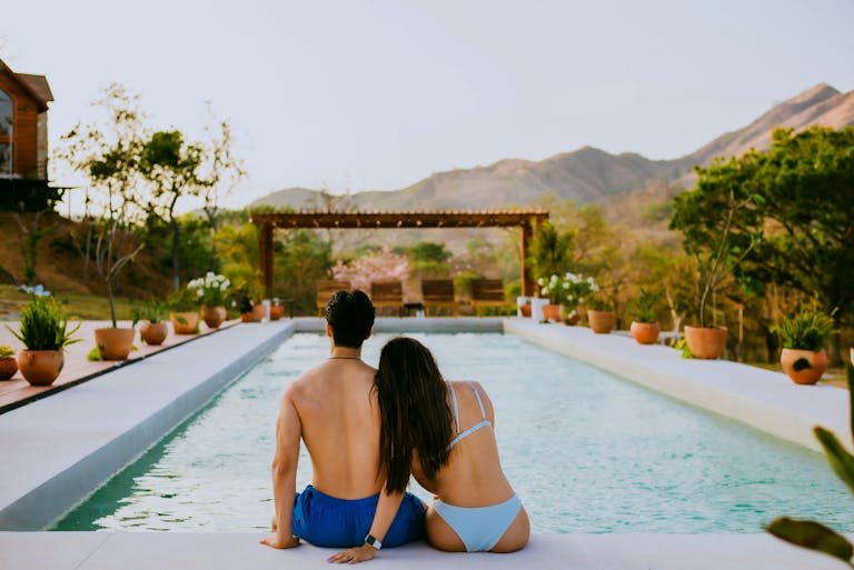 A Couple Sitting by a Pool