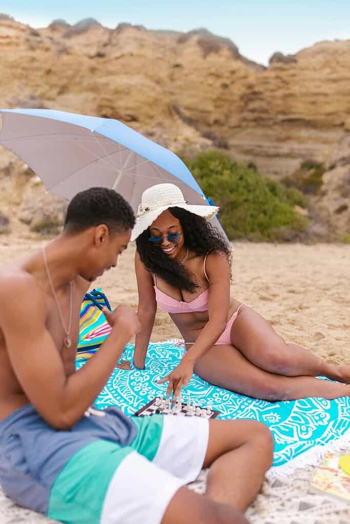 Woman and man Playing Chess at the Beach