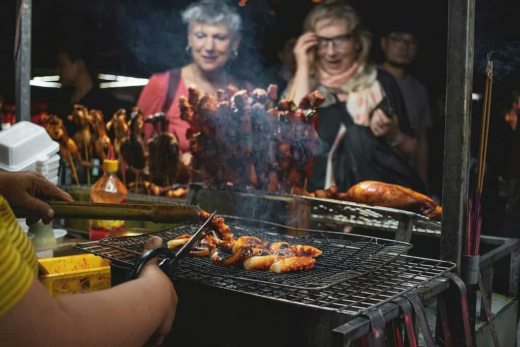 People Watching Barbecues Getting Cooked